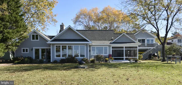 a front view of a house with a yard table and chairs