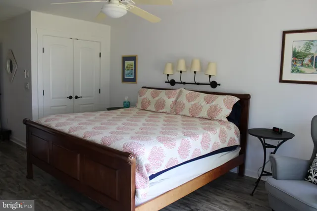 a kitchen with stainless steel appliances kitchen island granite countertop a table chairs in it and wooden floors