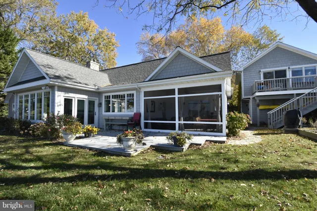 a front view of a house with a yard fire pit and outdoor seating