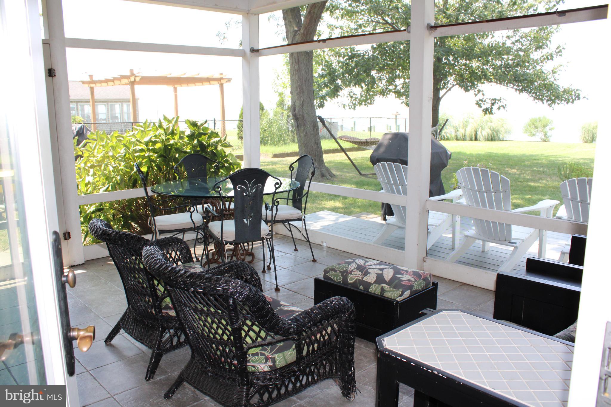 6050 Sunset Lane Tilghman, MD 21671 - Photo 70 of 74 a view of a dining room with furniture window and outside view