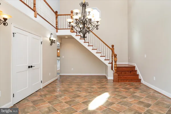 a view of a hallway with wooden floor and windows