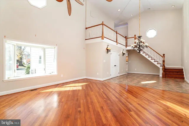 a view of a hallway with wooden floor and windows
