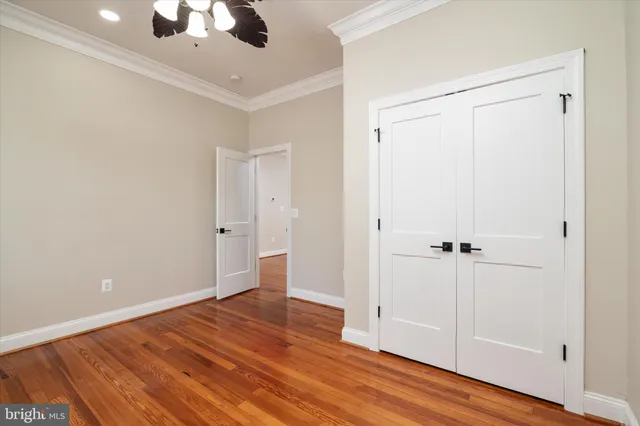 a view of a backyard with plants and brick wall