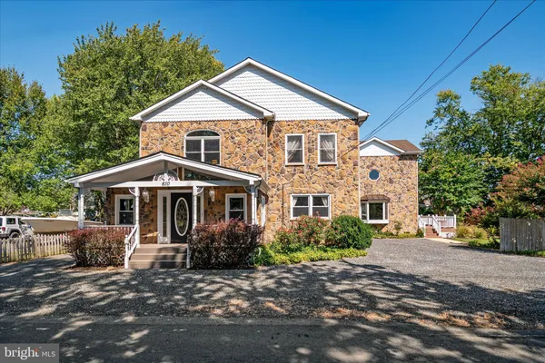 a view of a house with brick walls and flower plants