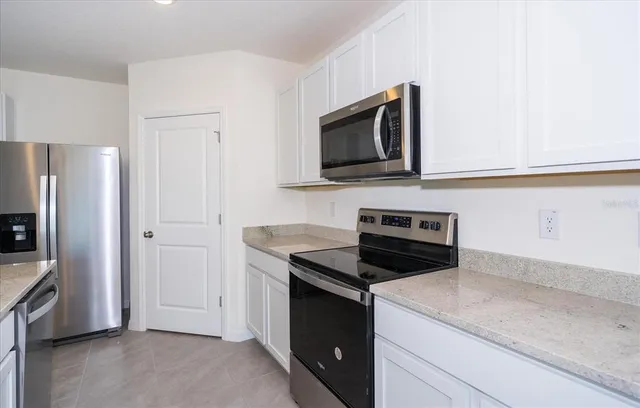 a kitchen with a stove microwave and refrigerator