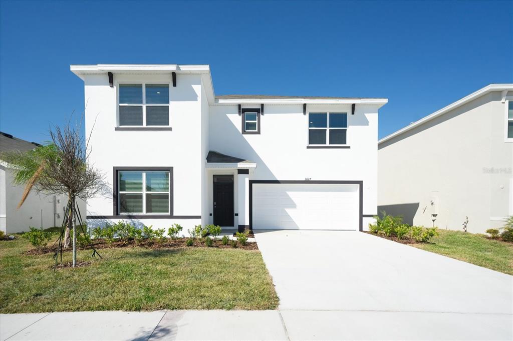 31127 Penny Surf Loop Wesley Chapel, FL 33545 - Photo 2 of 33 a front view of a house with a yard