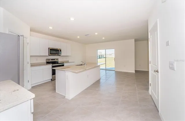 a view of a kitchen with microwave and cabinets