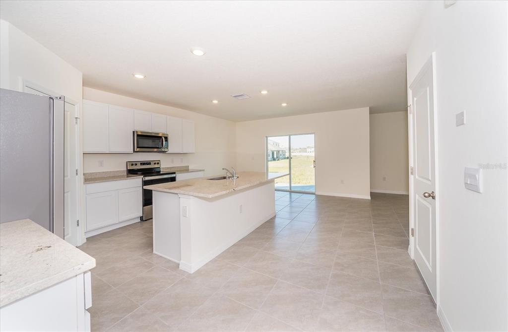31127 Penny Surf Loop Wesley Chapel, FL 33545 - Photo 9 of 33 a view of a kitchen with microwave and cabinets