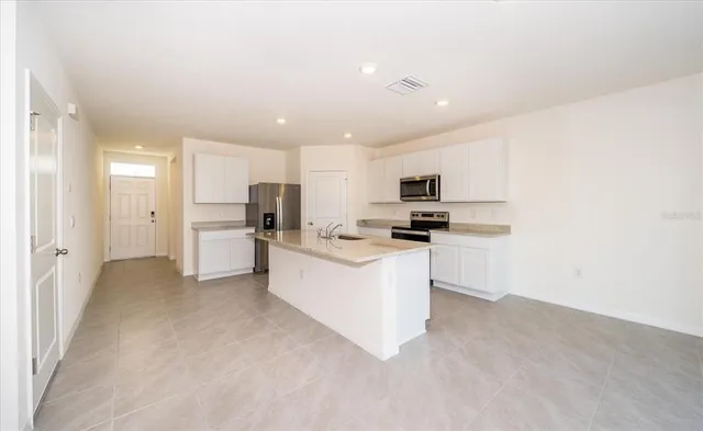 a kitchen with white cabinets and white appliances