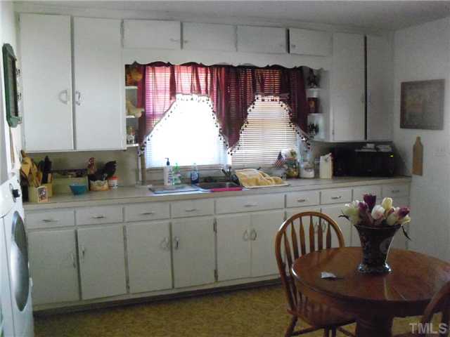 1232 Pointer Street Roxboro, NC 27573 - Photo 2 of 13 Kitchen has lots of cabinets and double windows for lots of natural light