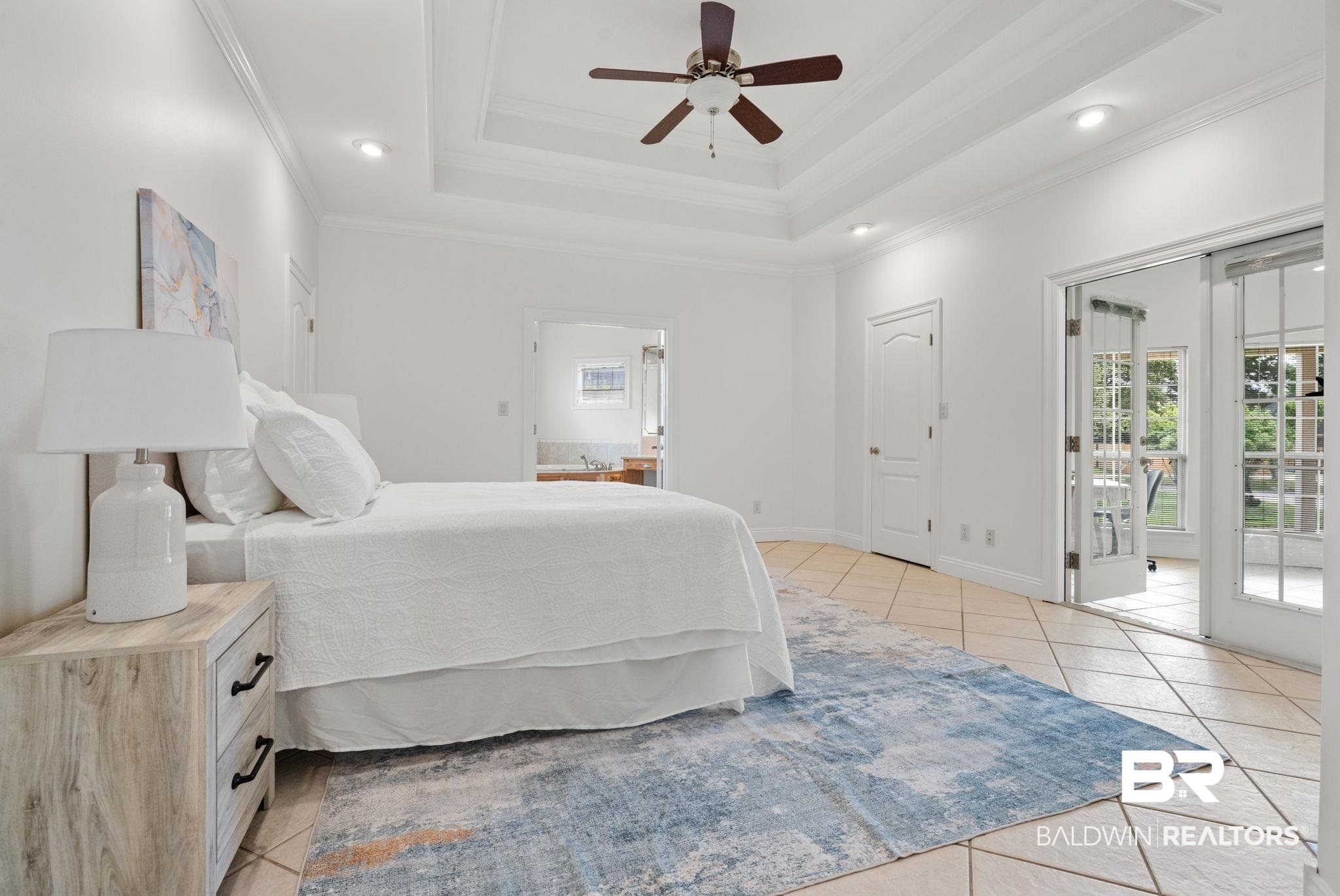 29634 St George Street Daphne, AL 36526 - Photo 25 of 47 Bedroom with multiple windows, access to outside, ceiling fan, a raised ceiling, and light tile patterned floors
