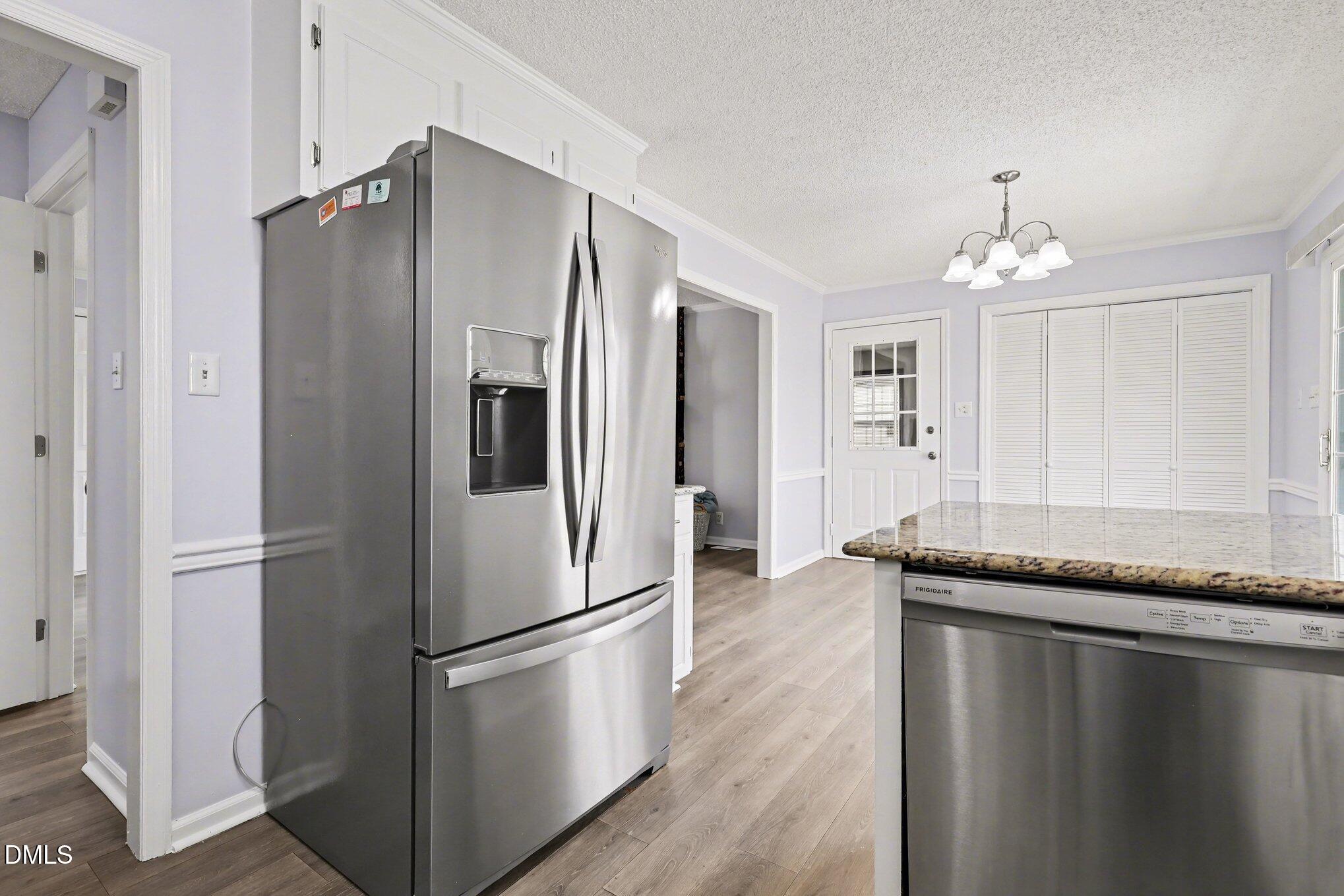 2020 Spring Valley Drive Clayton, NC 27520 - Photo 12 of 32 a kitchen with granite countertop stainless steel appliances a refrigerator and a counter space