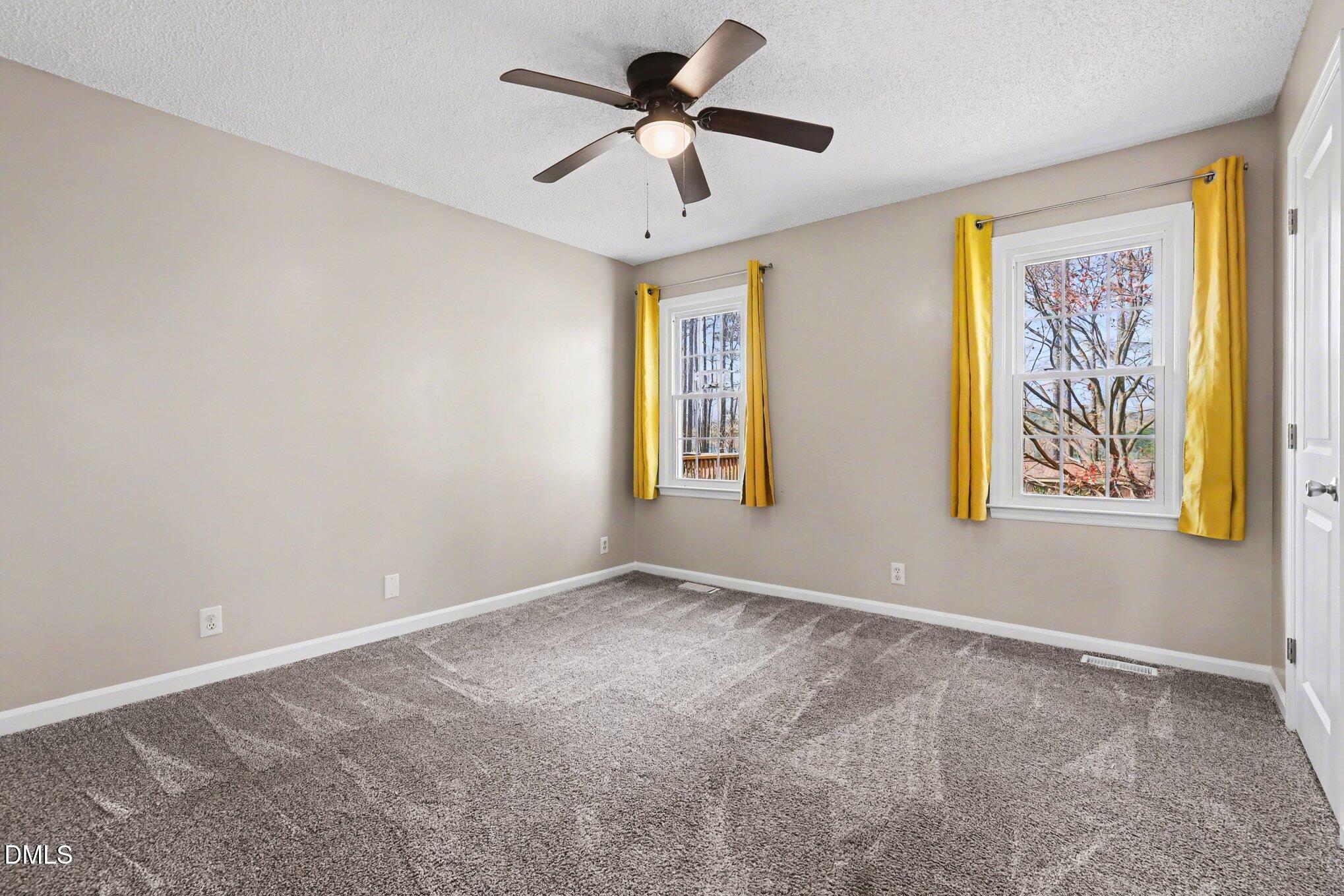 2020 Spring Valley Drive Clayton, NC 27520 - Photo 13 of 32 a view of a livingroom with a window and a ceiling fan