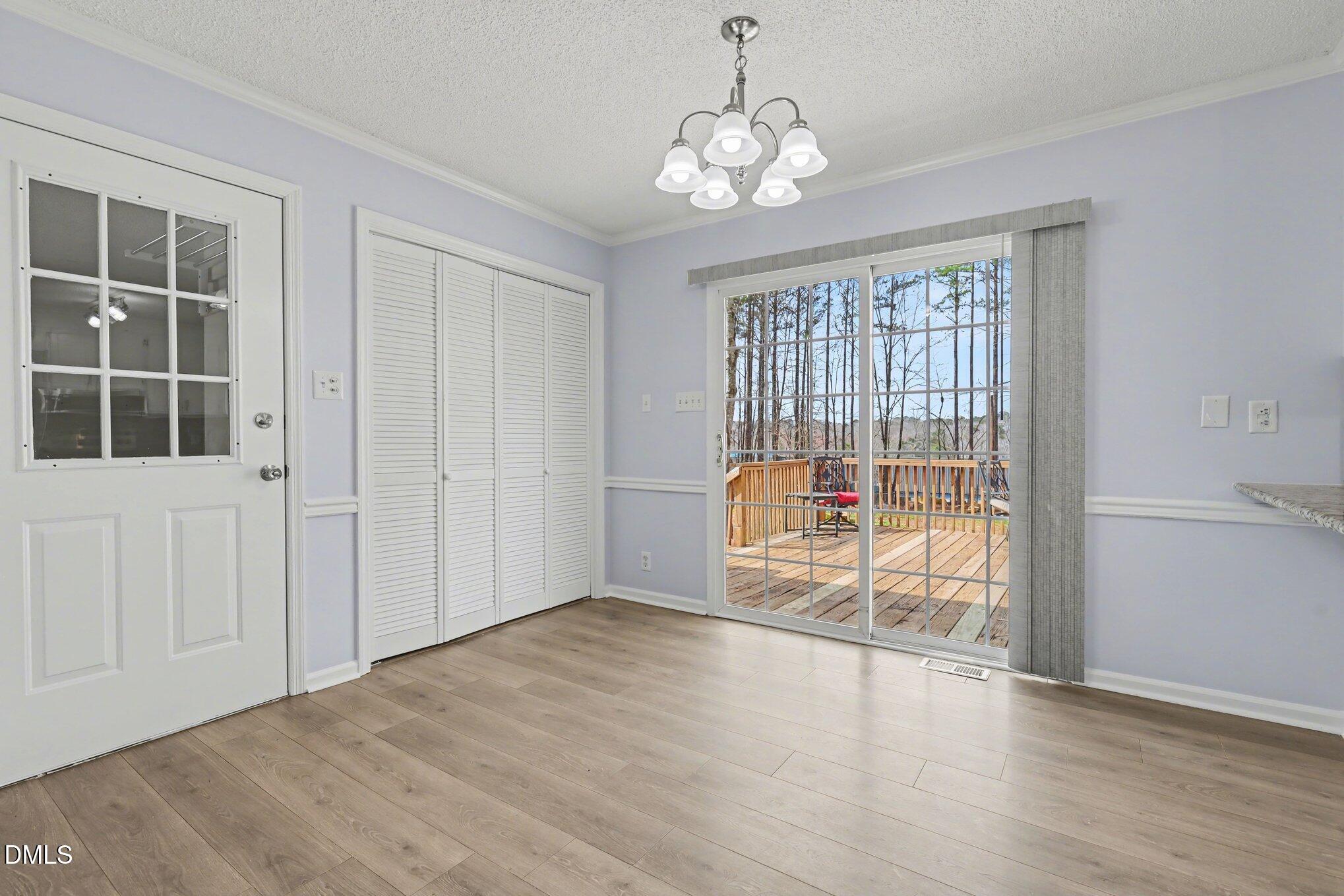 2020 Spring Valley Drive Clayton, NC 27520 - Photo 21 of 32 an empty room with wooden floor and windows