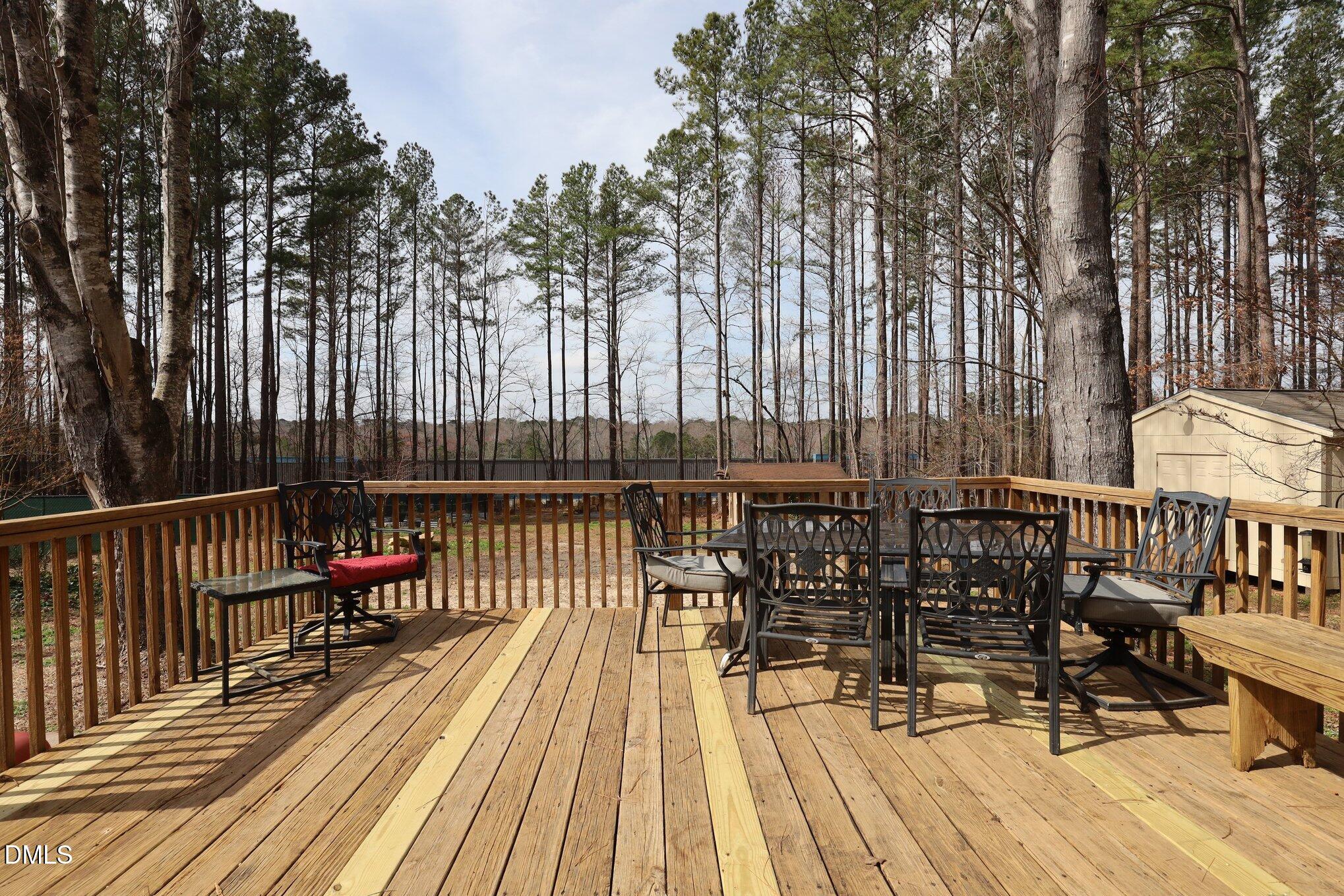 2020 Spring Valley Drive Clayton, NC 27520 - Photo 22 of 32 a balcony with wooden floor table and chairs