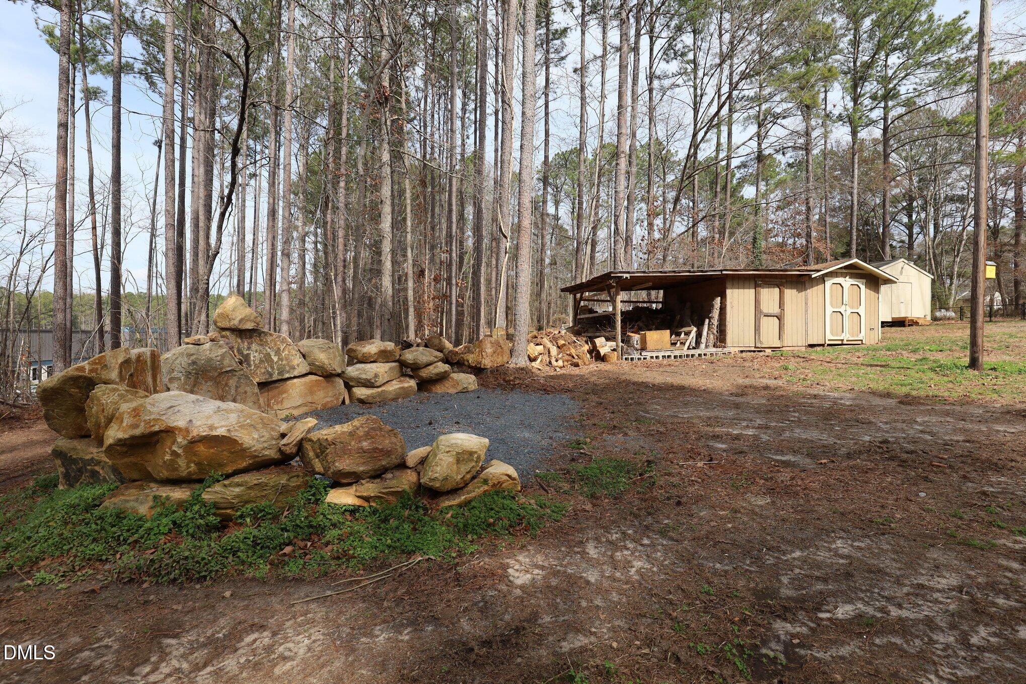 2020 Spring Valley Drive Clayton, NC 27520 - Photo 24 of 32 a backyard of a house with table and chairs