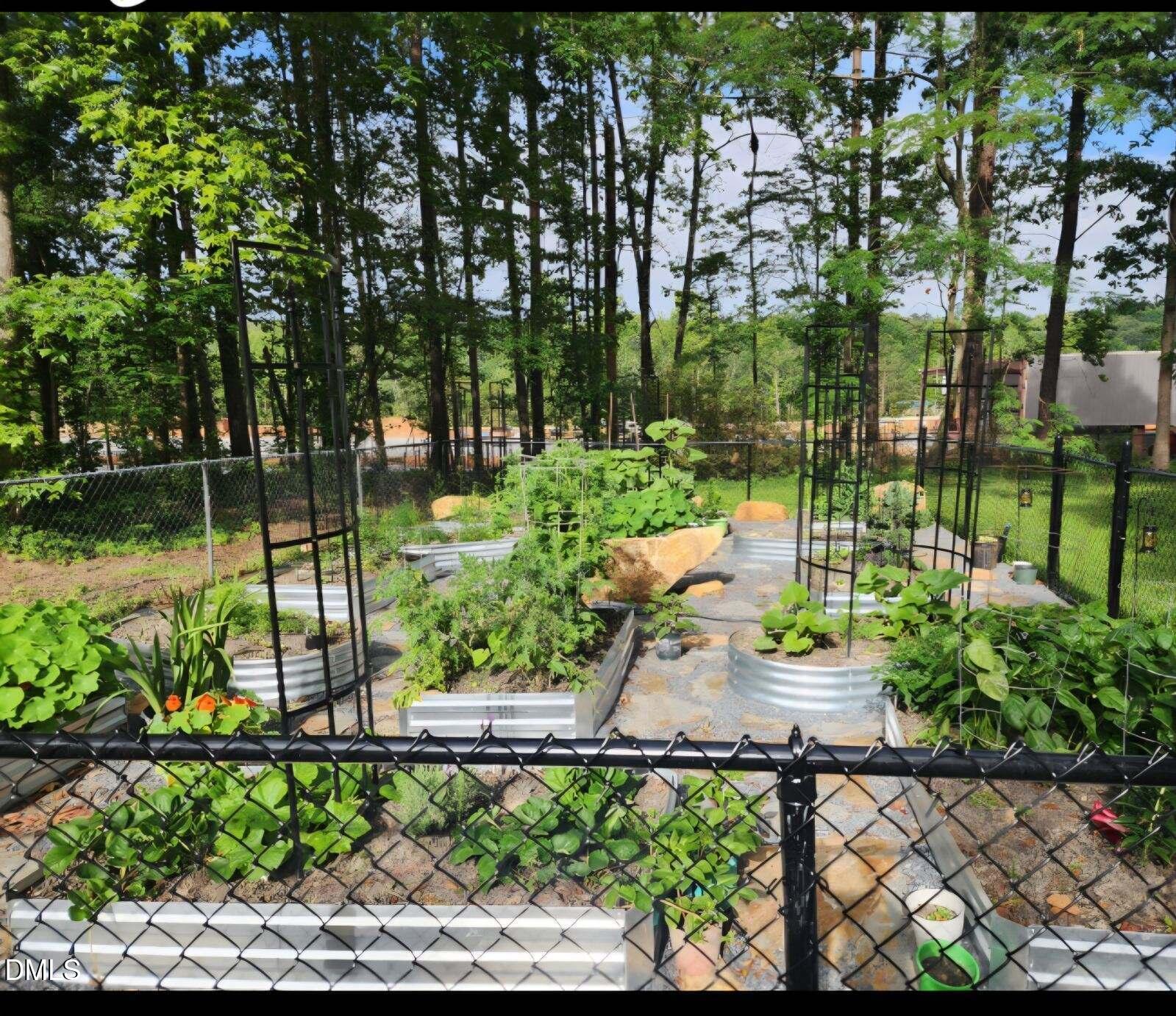 2020 Spring Valley Drive Clayton, NC 27520 - Photo 27 of 32 a view of a garden with a bench in a garden