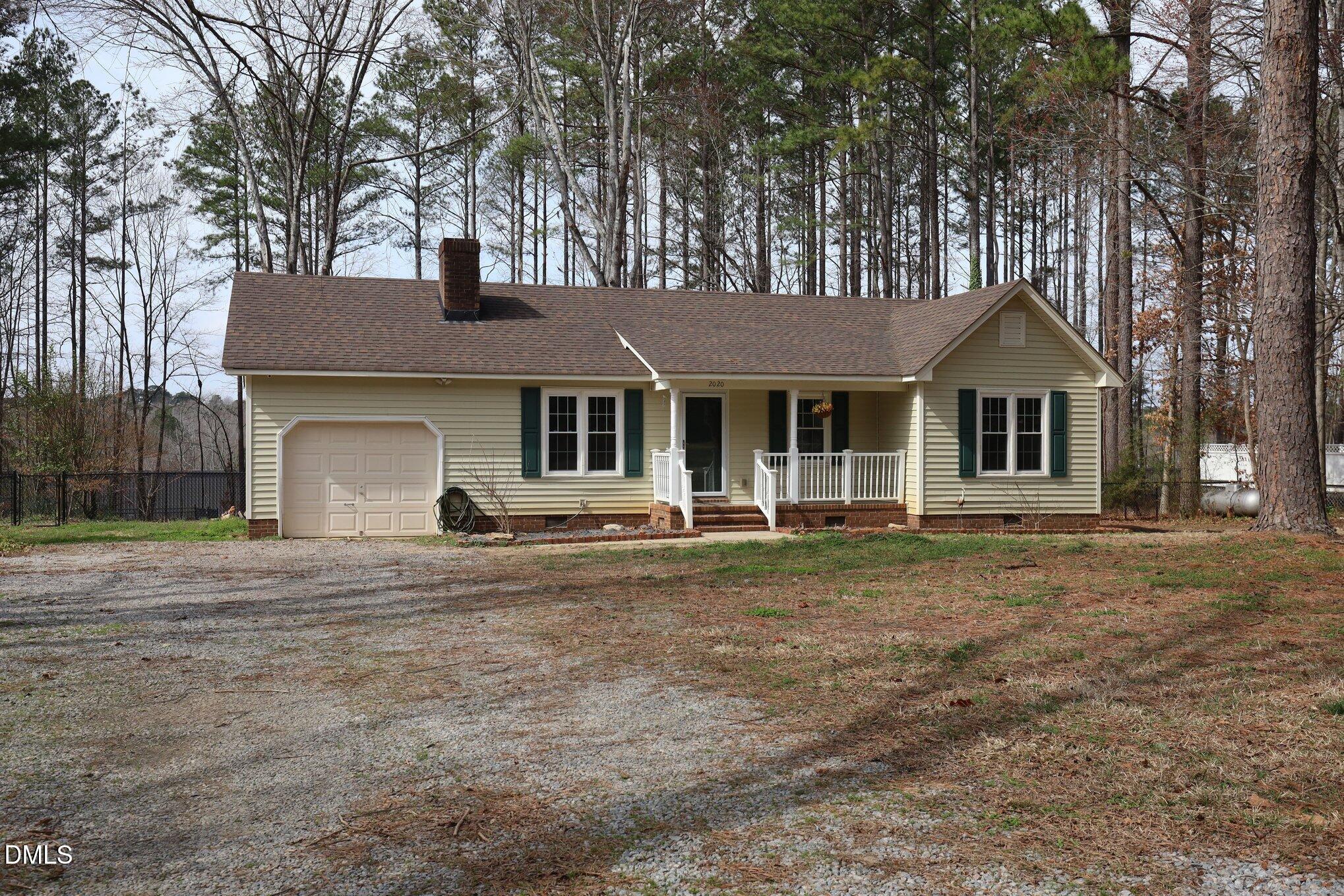 2020 Spring Valley Drive Clayton, NC 27520 - Photo 4 of 32 a front view of a house with a garden