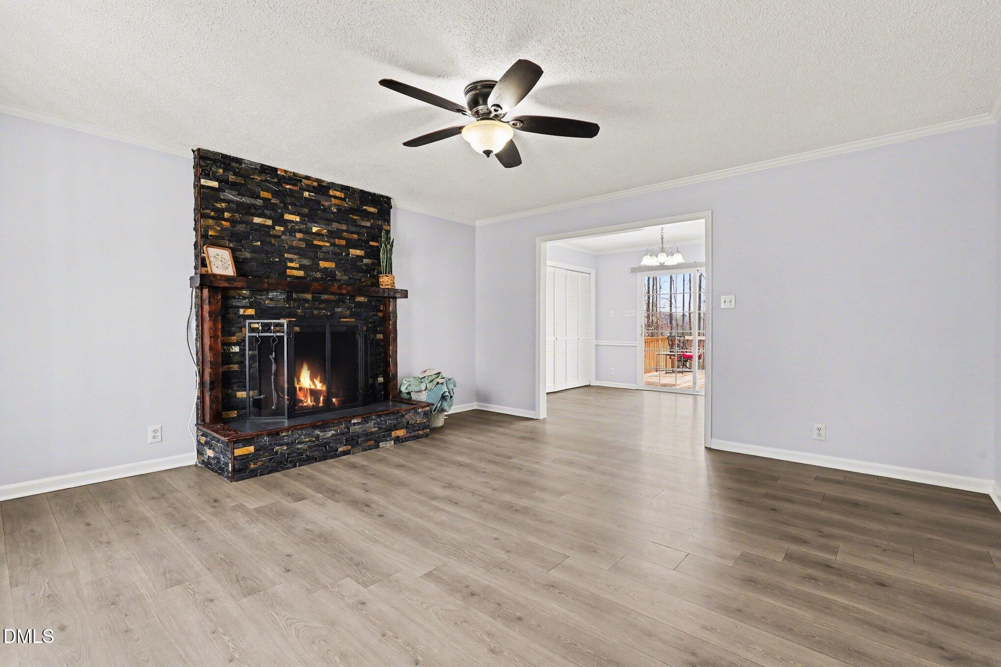 2020 Spring Valley Drive Clayton, NC 27520 - Photo 5 of 32 a view of an empty room with wooden floor and a fireplace