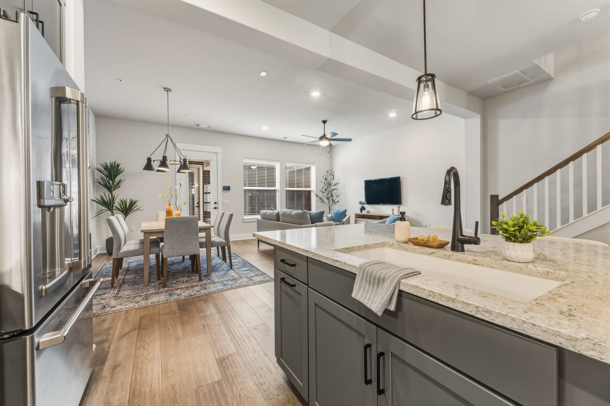 2929 Moreno Street Austin, TX 78723 - Photo 13 of 40 Kitchen island with a built-in sink, dark cabinetry, and light-toned countertops