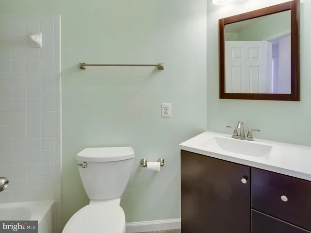 an empty room with wooden floor and closet