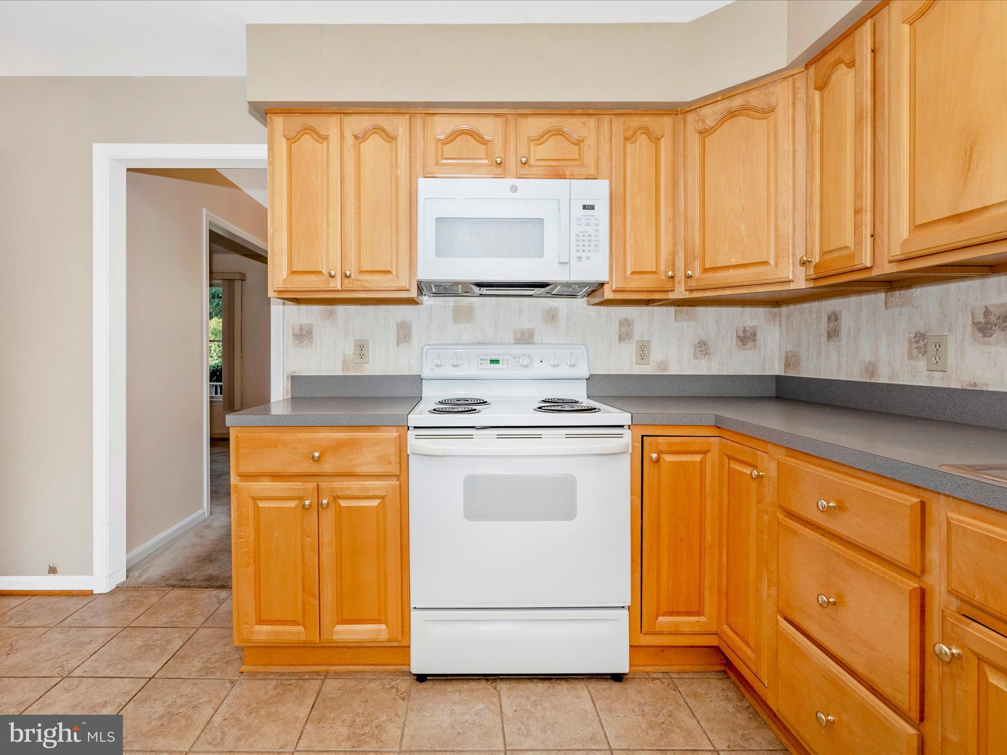 8170 Claiborne Drive Frederick, MD 21702 - Photo 16 of 70 a kitchen with stainless steel appliances granite countertop white cabinets sink and a granite counter top