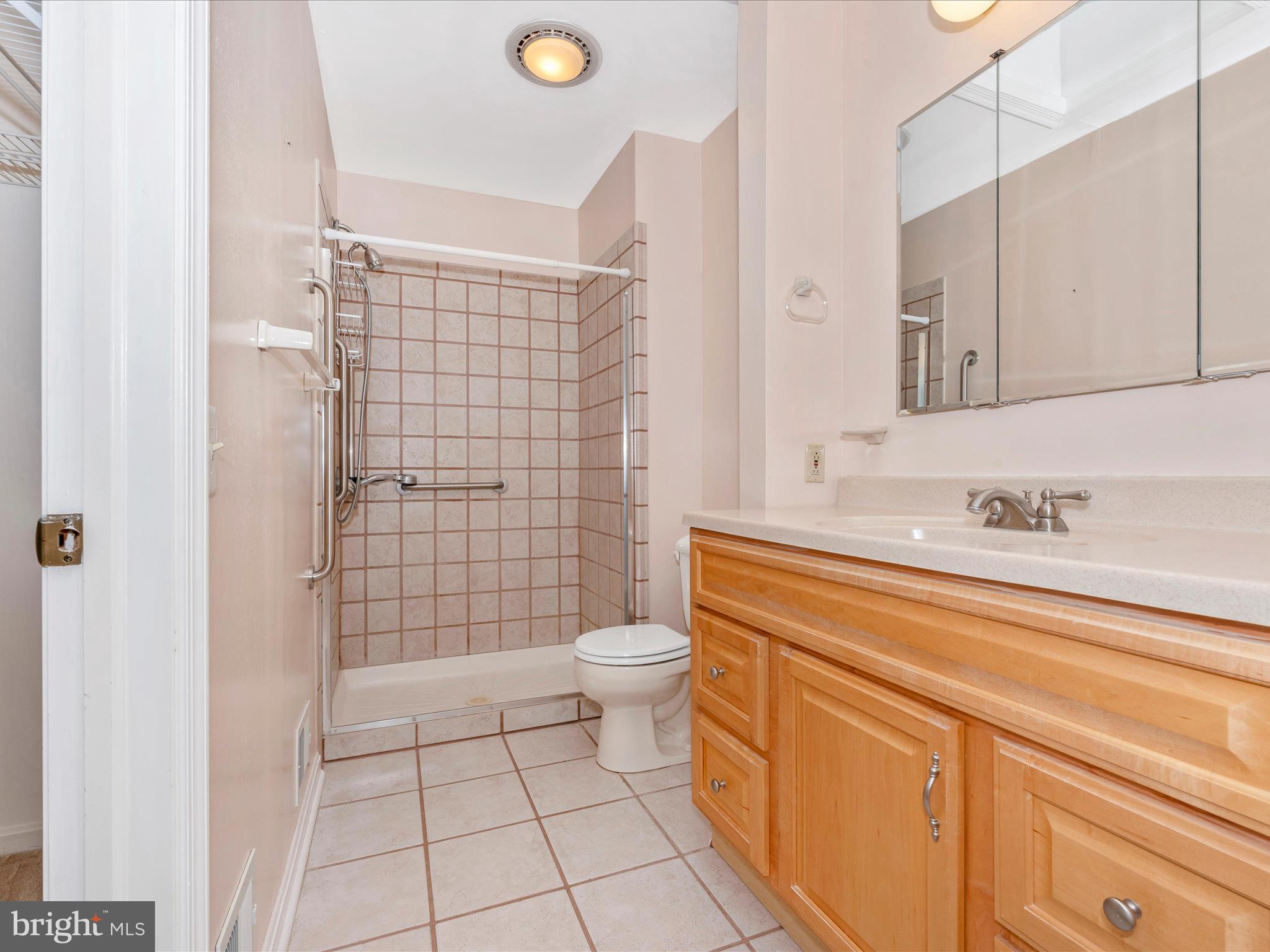 8170 Claiborne Drive Frederick, MD 21702 - Photo 28 of 70 a bathroom with a sink a toilet and shower