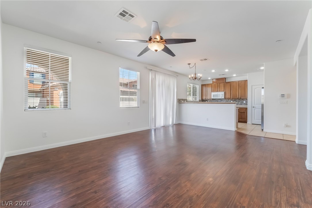 3175 Via Seranova Henderson, NV 89044 - Photo 10 of 45 This bright living space features rich hardwood flooring and an open view to the kitchen.