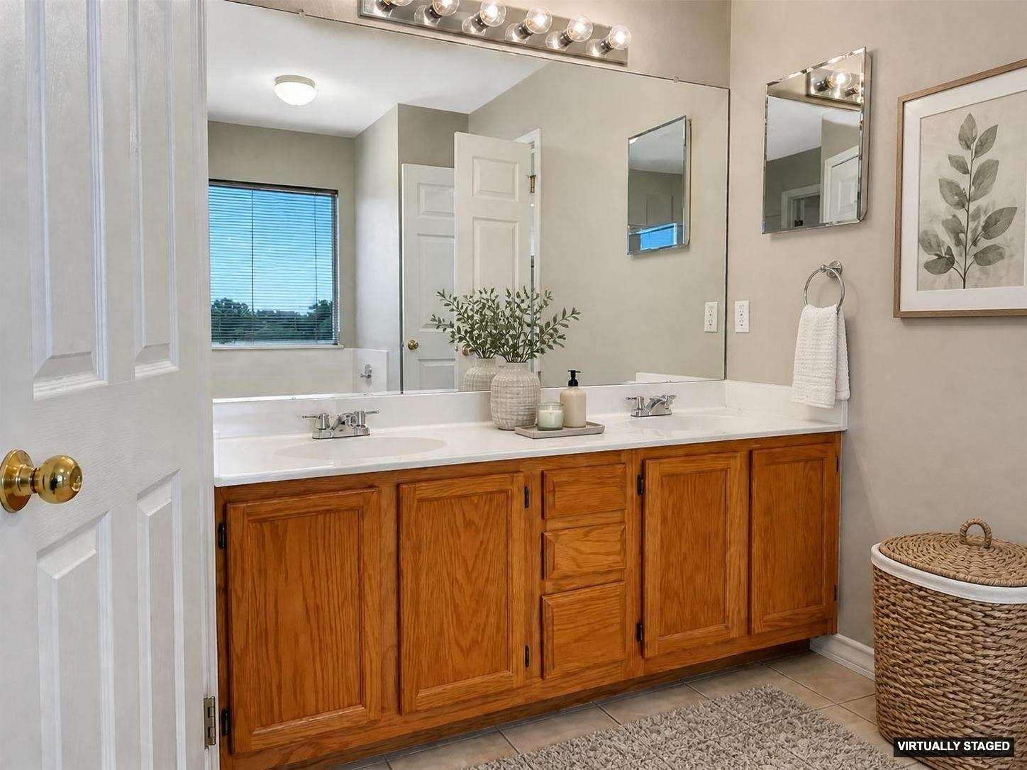 14828 Single Trace Austin, TX 78728 - Photo 17 of 30 Bathroom featuring a dual-sink vanity with wood-finish cabinetry, a large mirrored wall, and overhead vanity lighting