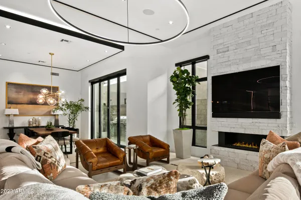 a living room with furniture a fireplace and a flat screen tv