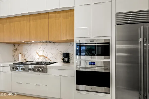 a kitchen with a stove and a refrigerator