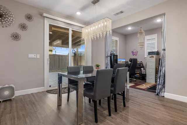 a living room with furniture a flat screen tv and a window