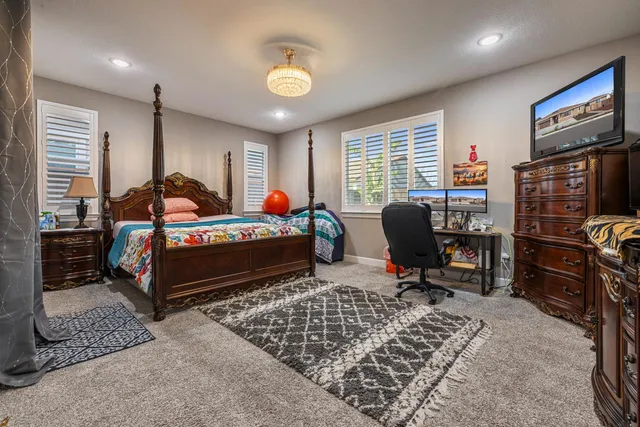 a bathroom with a sink a toilet a mirror and shower