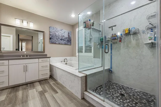 a bathroom with a double vanity sink a mirror and shower