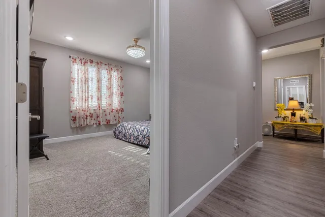 a bedroom with a large bed and a chandelier