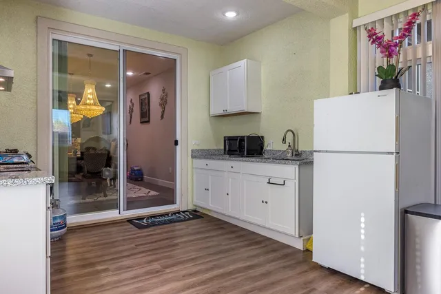 a spacious bedroom with a bed and a dresser