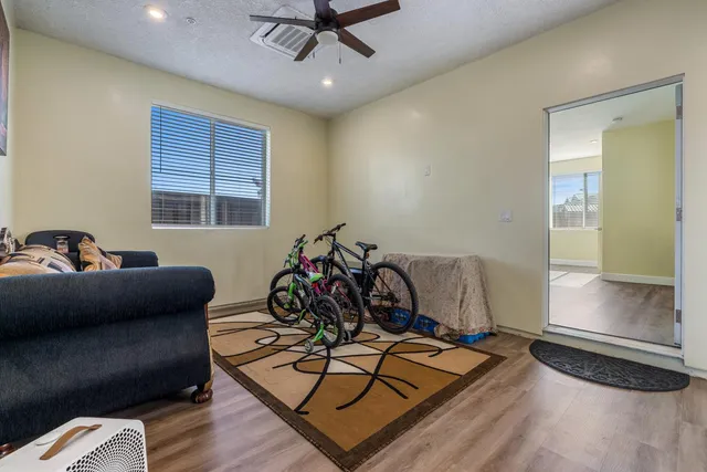 a bathroom with a bathtub a double vanity sink a vanity a window and a mirror