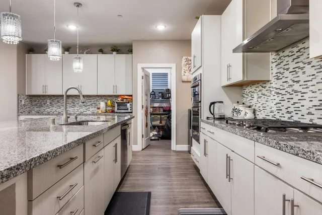 a large kitchen with a table and chairs