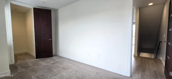 a view of hallway with wooden floor
