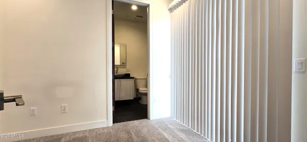 a view of a bedroom from a hallway