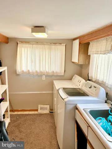 a utility room with a sink washer and dryer