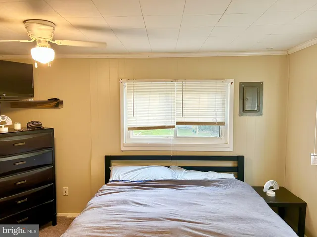 a bedroom with a bed and a window