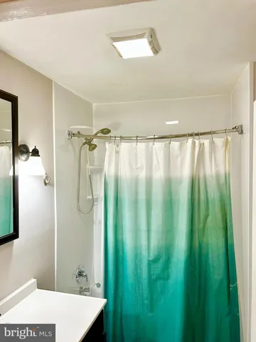 a bathroom with a shower and a bath tub