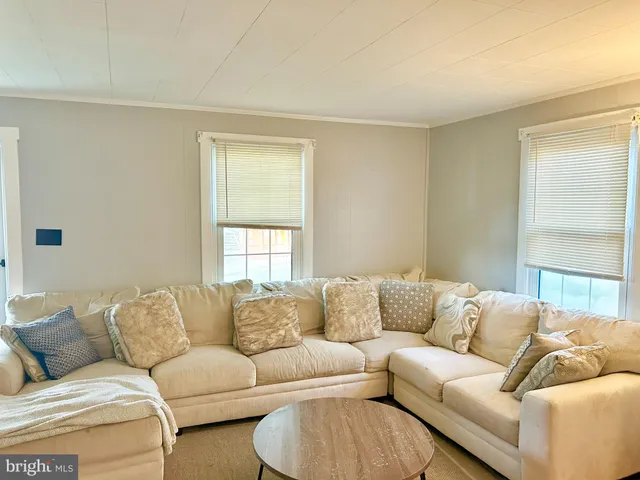 a living room with a couch and a window