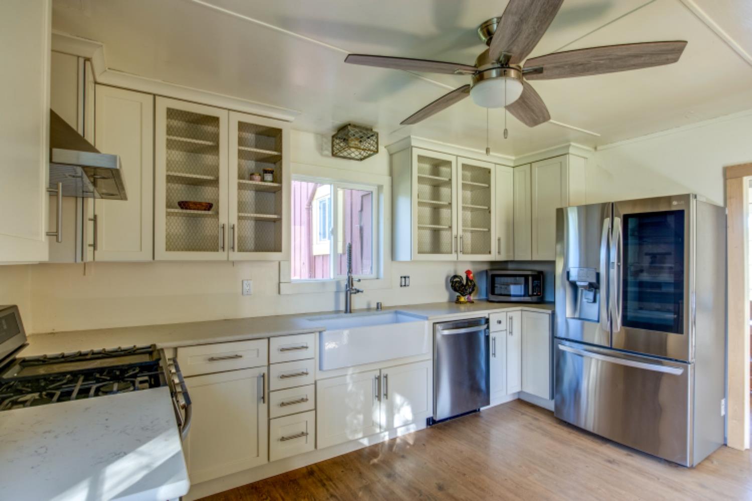 5700 Semor Drive Shingle Springs, CA 95682 - Photo 16 of 92 a kitchen with cabinets wooden floor and stainless steel appliances