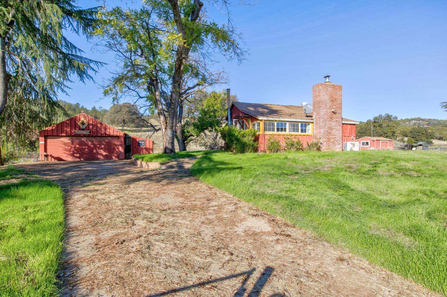 5700 Semor Drive Shingle Springs, CA 95682 - Photo 24 of 92 a front view of a house with a yard and garage