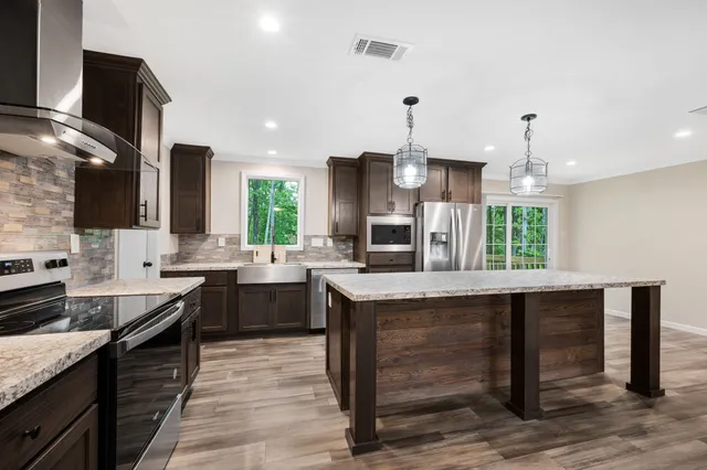 a kitchen with counter top space appliances and cabinets