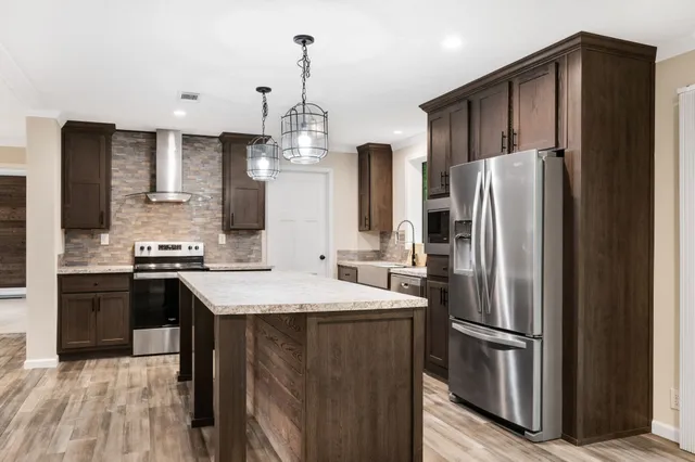 a kitchen with stainless steel appliances a refrigerator and a stove