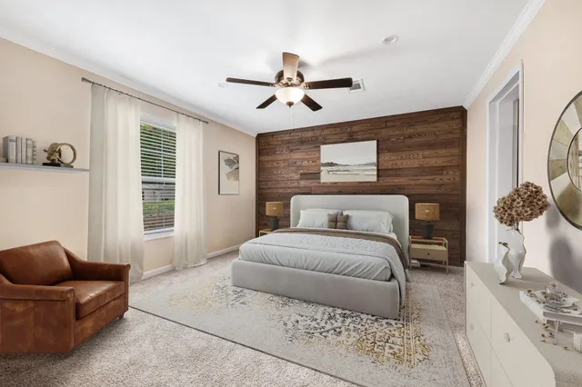 a spacious bedroom with a bed a couch and a window