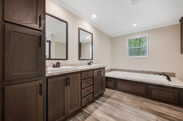 a bathroom with a double vanity sink and a bathtub